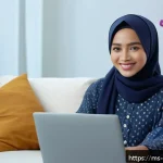 Home 20 심리학 연구동향 - A young Malay woman sitting comfortably in a modern living room, wearing modest casual clothing, eng...